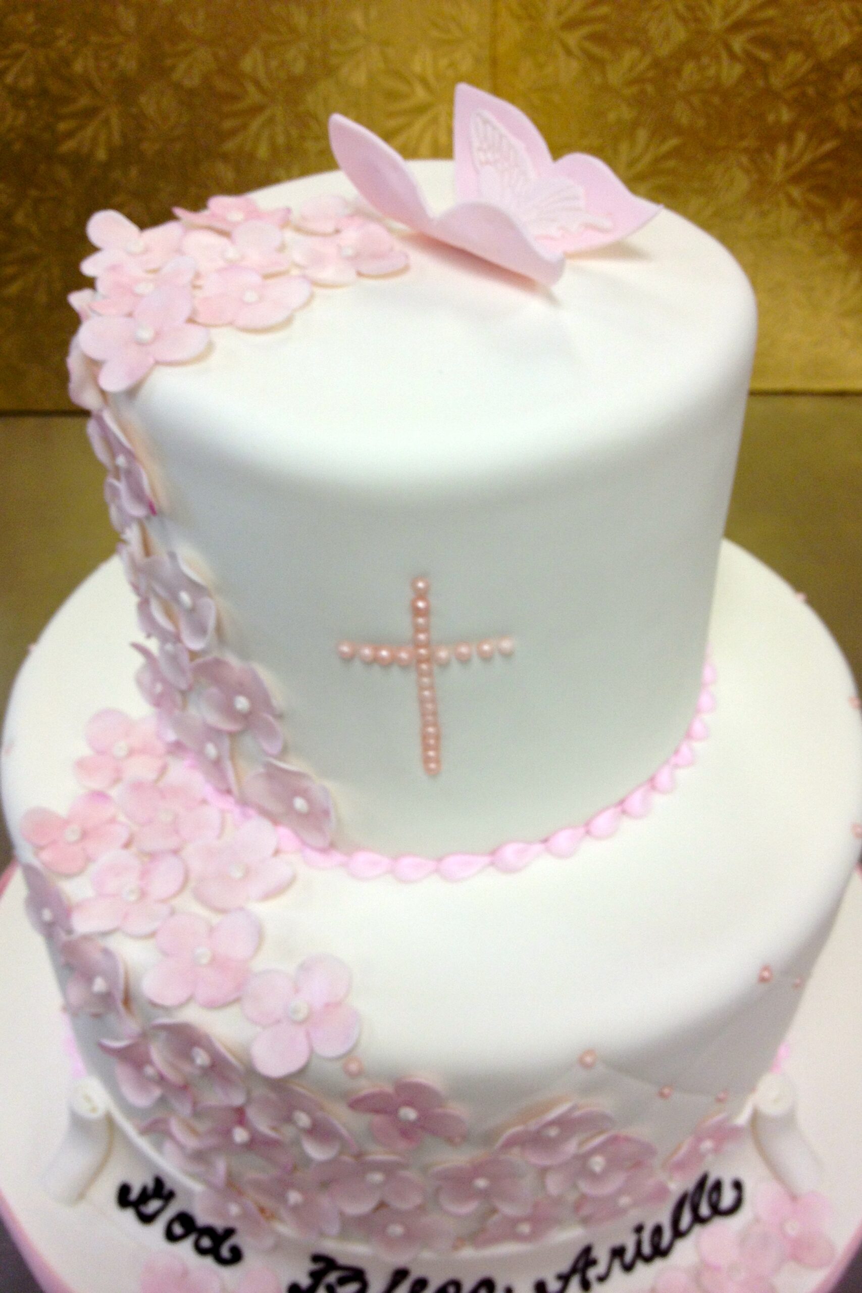 2 tier pink and white cake with cross