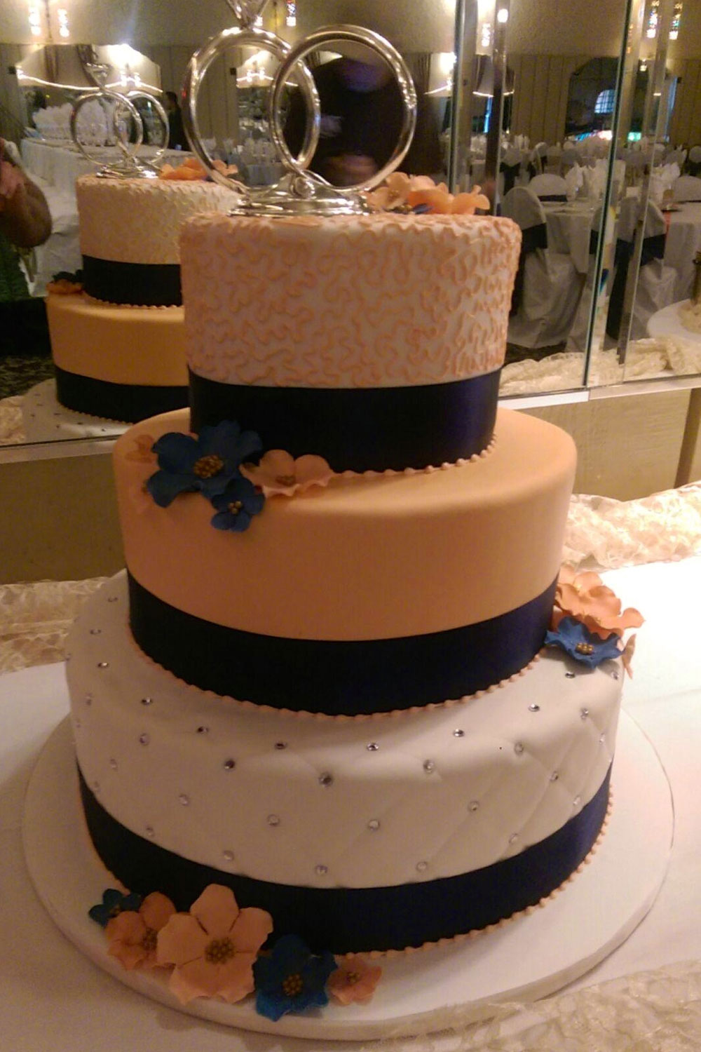 Coral and Navy Contrast wedding cake with Flowers and Rhinestones