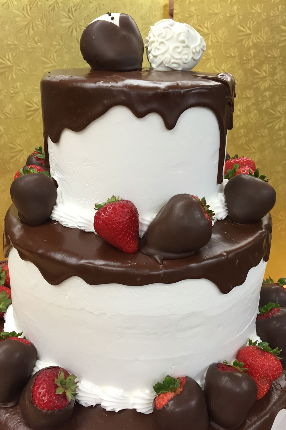 Wedding cake with chocolate covered strawberries