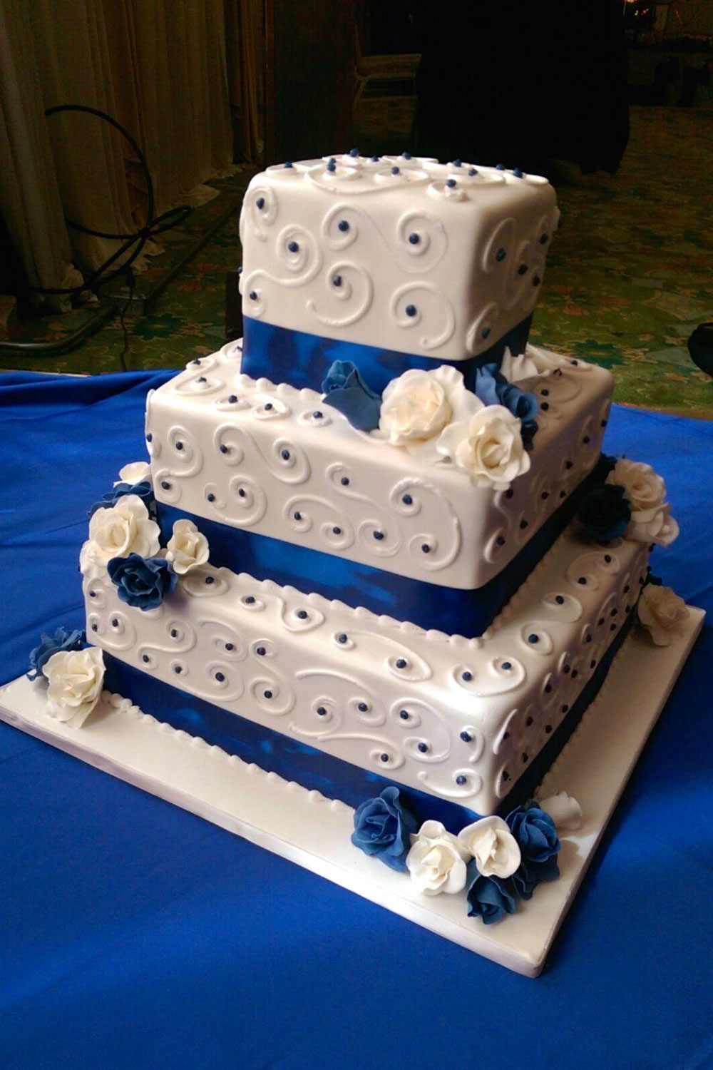 Wedding cake with Royal Blue with White Piping and Rose Clusters