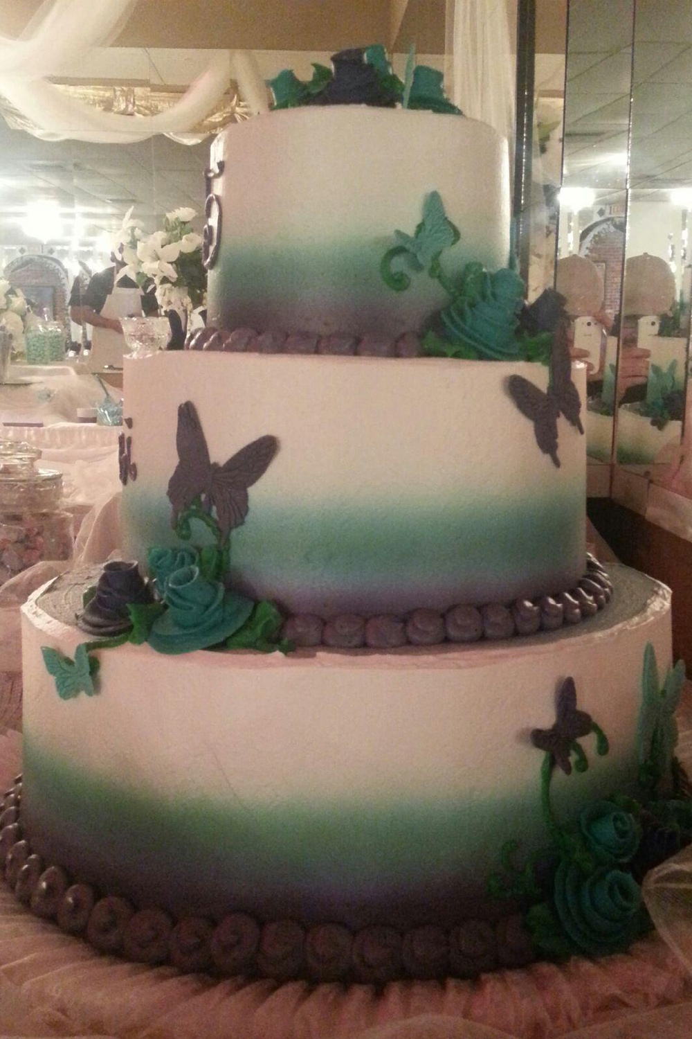 Teal and white Butterfly Spray Fade Quinceanera tier cake