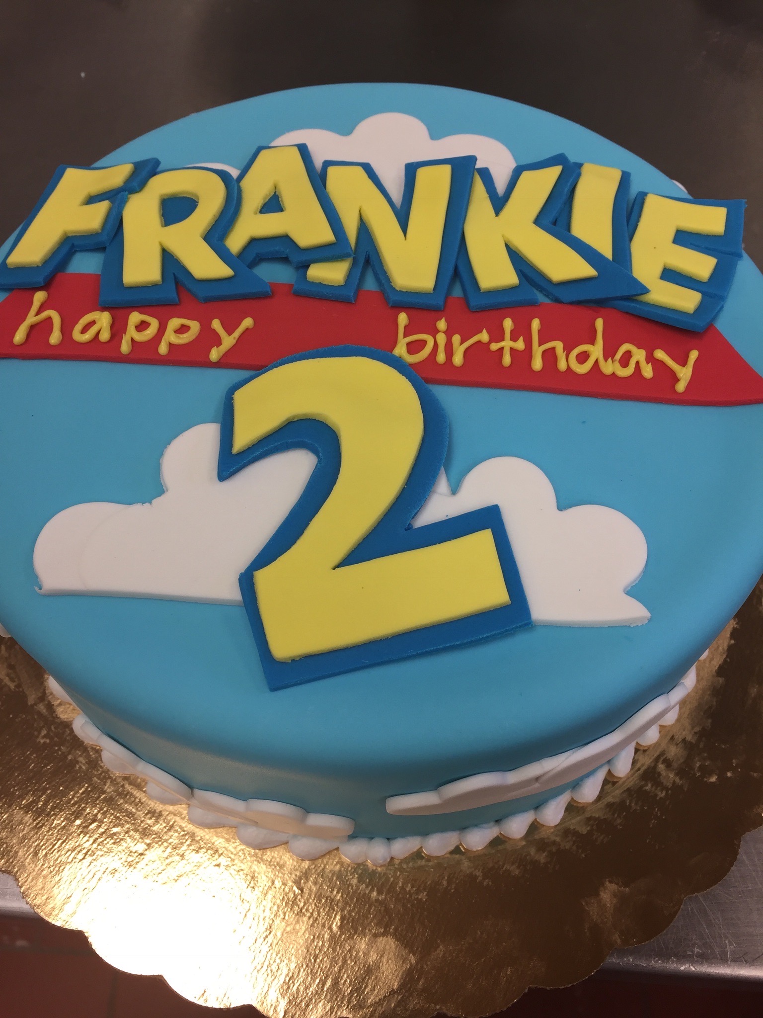 Toy Story fondant cake with title font and clouds