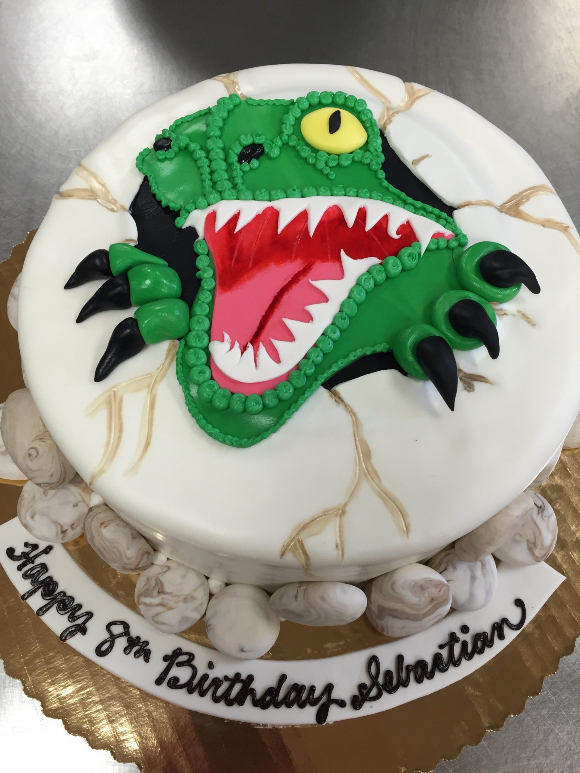 Dinosaur coming out of an egg fondant cake
